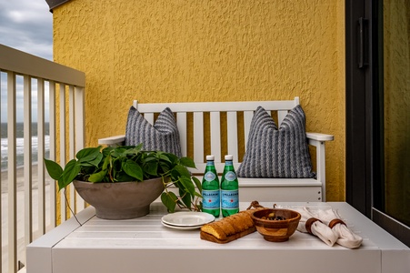 Savor your morning coffee on this charming balcony, where fresh greenery and thoughtful touches create your perfect retreat.