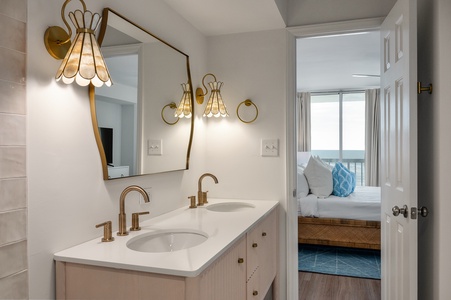 Your spa-like ensuite features gleaming brass fixtures and dual vanities, with crisp linens awaiting in your peaceful bedroom beyond.