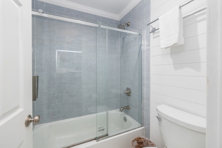The hallway bathroom is fitted with a tub-shower combo