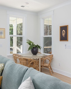 Settle into your bright dining nook where natural light streams through tall windows, creating the perfect spot for morning coffee or intimate meals.