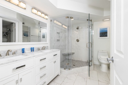 Indulge in your private spa-like bathroom with dual vanities, luxurious walk-in shower, and elegant marble finishes throughout.