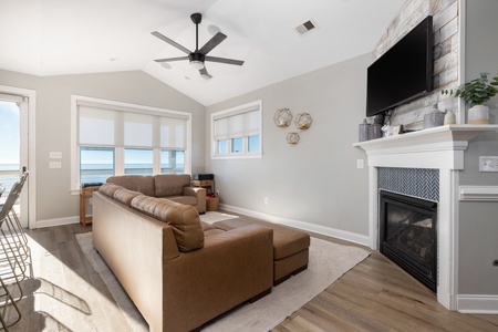 Steps off the kitchen is your large living room with plush leather seating