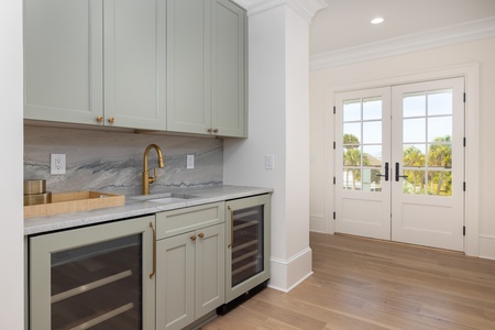A stylish wet bar with hand sink and two wine fridges