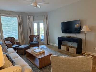 Sink into plush seating and enjoy your favorite shows on the large flat-screen TV in this beautifully appointed living room designed for relaxation.