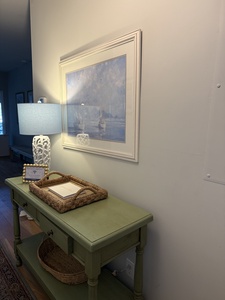 Your charming entry features a coastal-inspired console with nautical artwork that sets a serene tone for your stay.