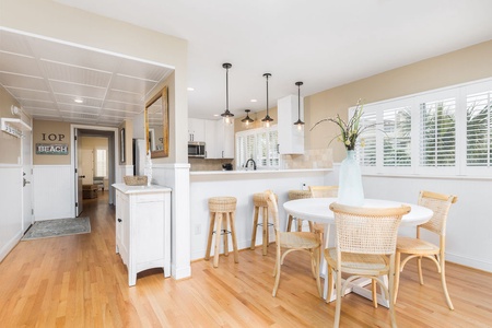 The dining table seats four and there are bar stools at the breakfast bar.