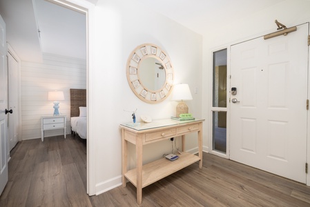 Your welcoming entryway features coastal-chic décor with a charming console table and decorative mirror, setting the tone for your relaxing stay.