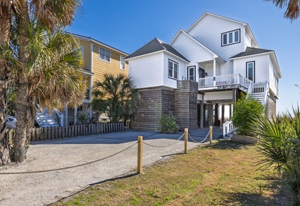 Coastal vacation homes with palm trees and tropical landscaping set the perfect scene for your beachside getaway.