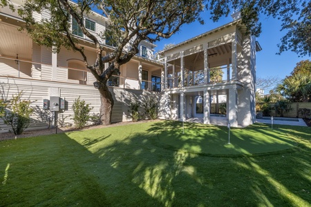 Private backyard putting green at this Isle of Palms vacation rental, offering a unique amenity for golfers, families, and groups visiting Charleston, SC