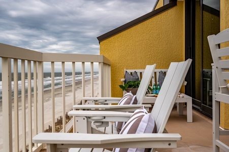 Unwind on your private oceanfront balcony with comfortable lounge chairs perfectly positioned for watching waves roll onto the sandy shore below.