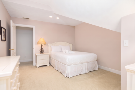 Your serene bedroom retreat awaits with soft lighting, plush bedding, and warm tones that invite restful nights. The cozy lamp and elegant furnishings create a peaceful atmosphere for unwinding after your adventures.