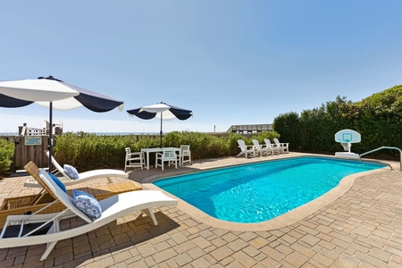 Spacious Pool Deck with Umbrella-Shaded Loungers – Perfect for your Folly Beach getaway.