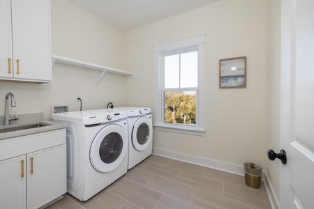 Your dedicated laundry room features full-size washer and dryer with convenient sink and ample counter space for folding.