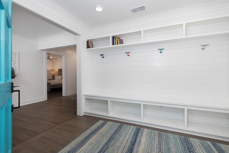 A welcoming entryway with built-in storage benches greets you