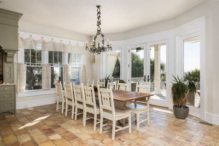 Your first dining table looks out to the back deck with views of the pool and ocean beyond