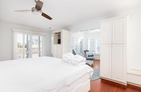 Your upstairs primary bedroom includes a bright sunroom with comfortable seating