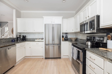 Spacious kitchen with stainless steel appliances, granite countertops, and plenty of prep space.