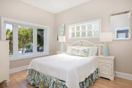The first floor queen bedroom looks out to the front of the house