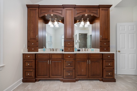 Beautiful dual vanity with rich wood cabinetry, elegant lighting, and plenty of storage to keep your morning routine seamless and stress-free.