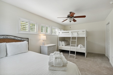 The second upstairs bedroom has a queen bed and a full-over-full bunk bed