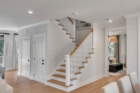 Your entryway leads past the beautiful staircase to the living and kitchen areas