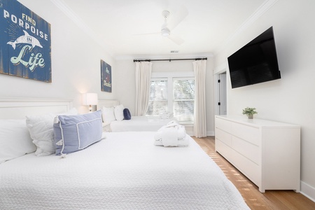 Your bright, coastal-themed bedroom features two full-sized beds