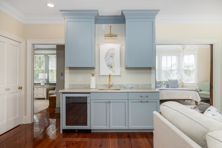 This newly finished wet bar features a wine fridge and sink