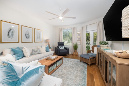 A plush sofa, leather recliner, and wicker arm chair adorn your coastal living room