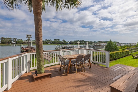 Enjoy morning coffee or sunset cocktails on your private waterfront deck, overlooking tranquil marina views framed by swaying palms and a lush coastal landscape.