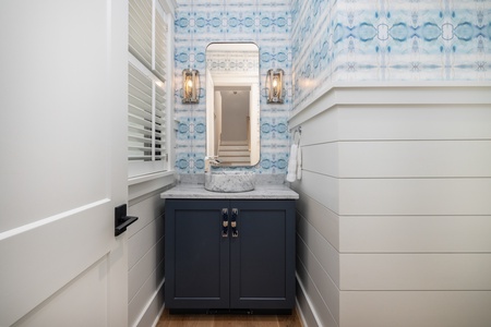 A first floor private powder room adds extra convenience and comfort