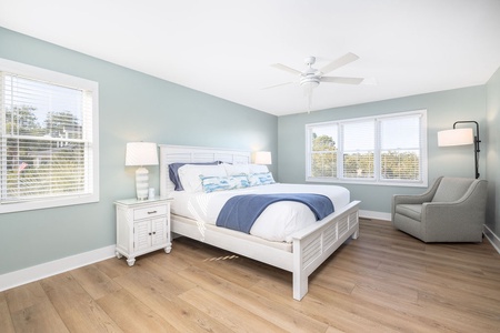 The serene primary bedroom includes a king bed and ensuite, with walk in shower.