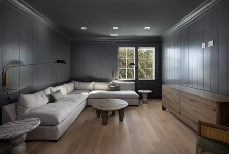 Sink into plush sectional seating in your sophisticated lounge, where dramatic paneled walls and natural light create the perfect retreat.