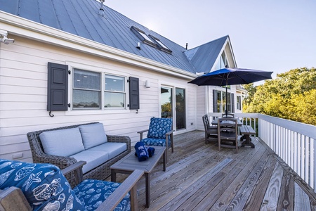 The expansive deck is the perfect place to enjoy the natural habitat. Unwind while dining alfresco or relaxing in the comfortable seating.