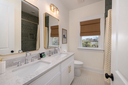 Your stylish bathroom features dual vanities, elegant gold accents, and charming details that make your morning routine feel luxurious and refreshing.