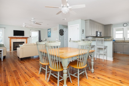 Gather around your spacious dining table while the kitchen island invites casual conversations and the cozy fireplace creates warmth.