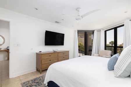 The primary bedroom has direct access to the private balcony