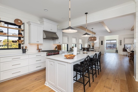 Cook and gather in your spacious gourmet kitchen with gleaming counters, premium appliances, and a breakfast bar perfect for morning coffee.