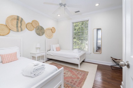 Bright twin bedroom with cozy beds and natural light.