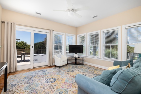 Unwind in your sunlit living room with deck access