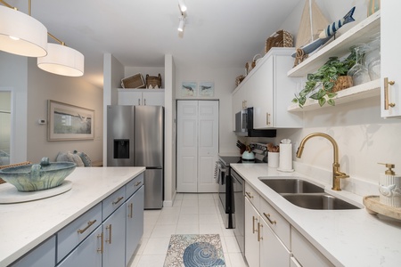 Cook in your beautifully appointed kitchen featuring golden brass fixtures and granite countertops