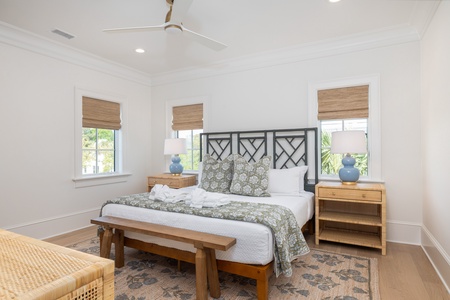 This king bedroom filters light through natural bamboo blinds