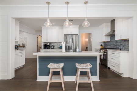 Elegant pendant lighting adorns the updated kitchen