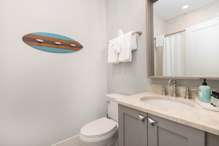 The king en suite bathroom has a tub-shower combo
