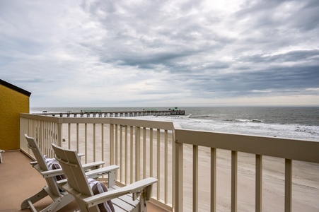 Relax in your beachfront chairs while waves crash below and watch the pier stretch into the ocean horizon.