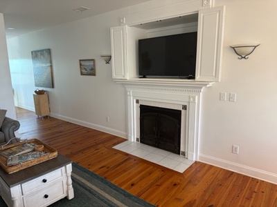 Unwind in your cozy living room with a crackling fireplace and smart TV for perfect evenings in.