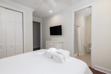 Your queen bedroom with a tv and en suite bathroom.