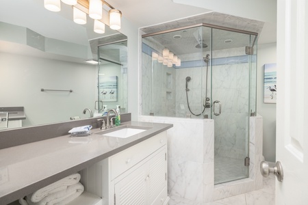 Your king en suite bathroom features a large walk-in shower