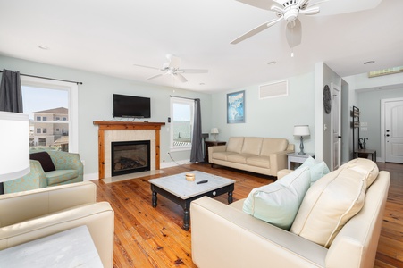 Relax in your spacious living room with cozy fireplace, plush seating, and warm wood floors that invite peaceful evenings together.