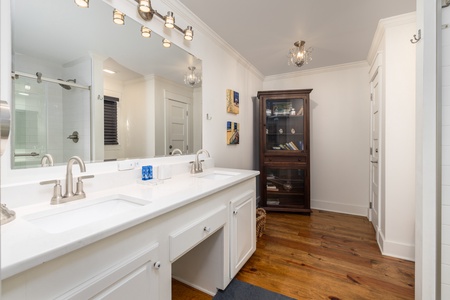 Step into your spa-like primary bathroom with a tiled walk-in shower and dual vanities
