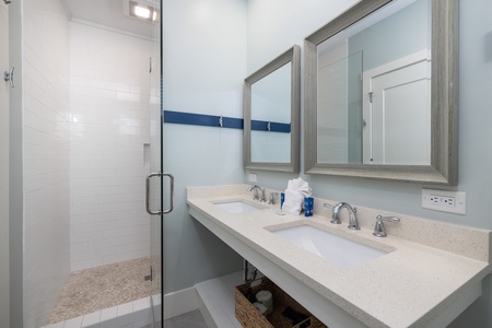 The queen en suite offers a glass shower and dual vanity